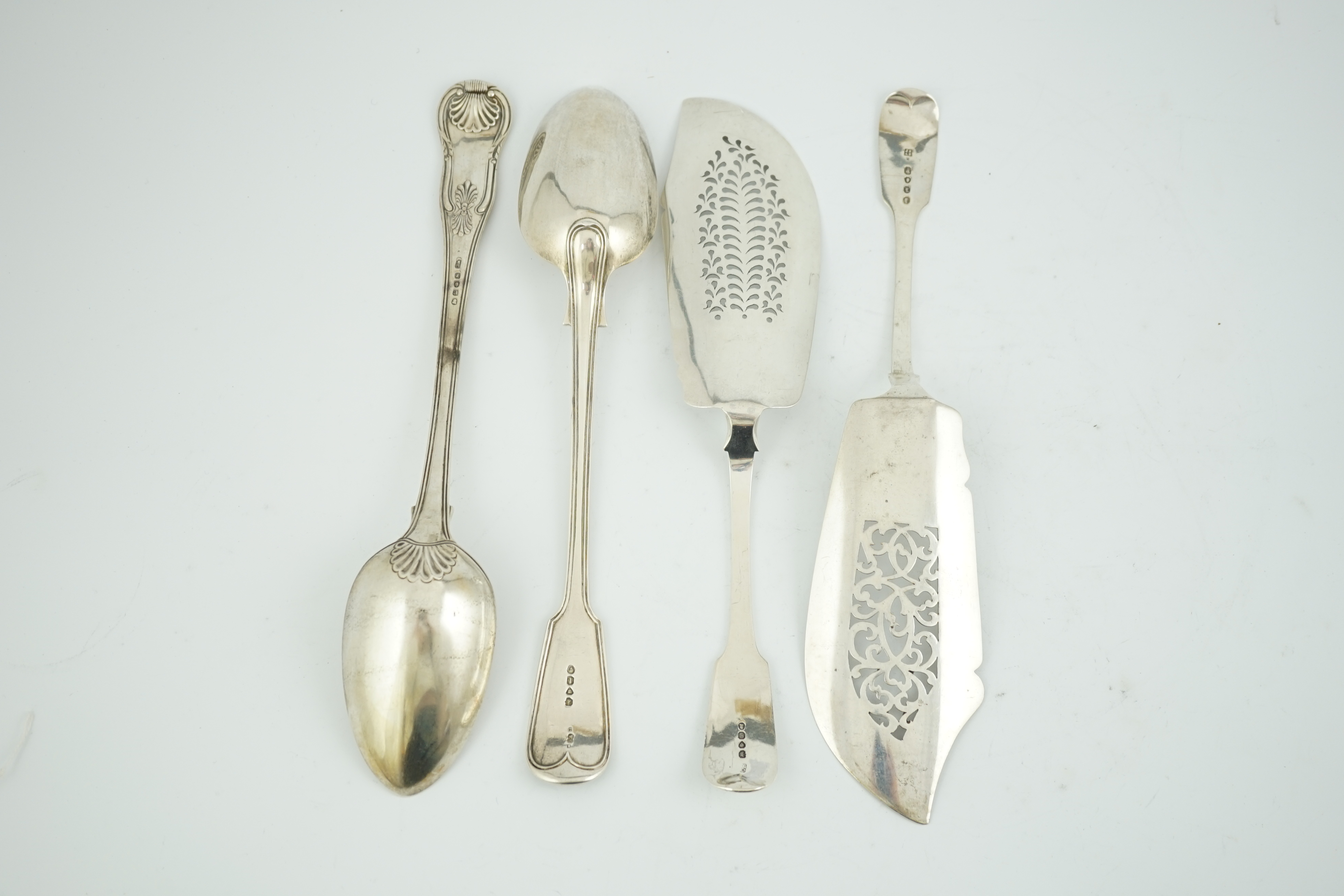 Two early 19th century silver fish slices, Charles Boyton, London, 1831 and Joseph & Albert Savory, London, 1846, largest 31.2cm, together with two 19th century silver basting spoons, William Chawner, London, 1816 and Ge